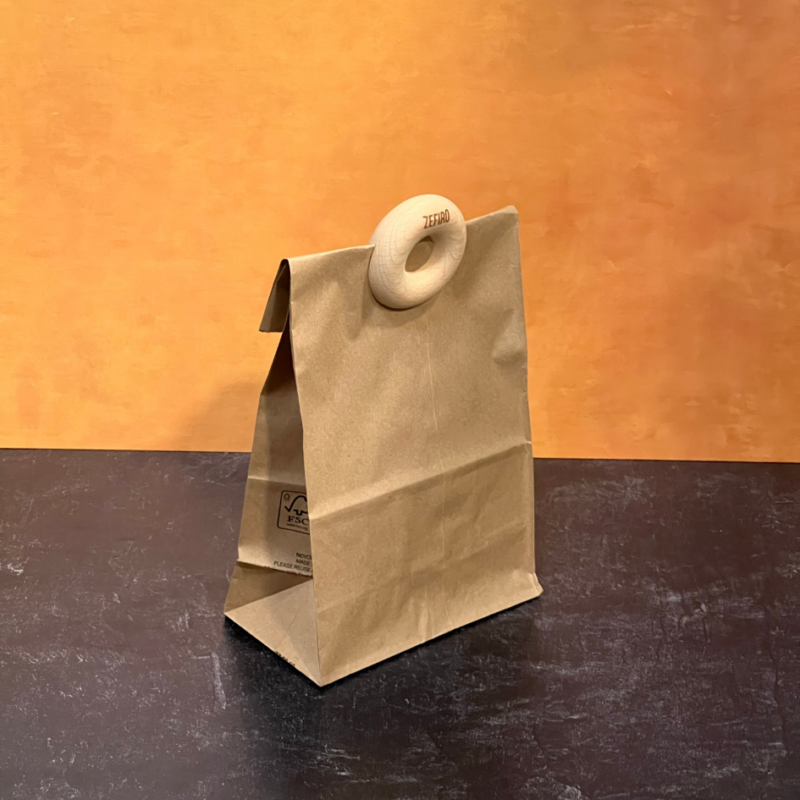 Zefiro circular wooden bag clip on a brown paper bag