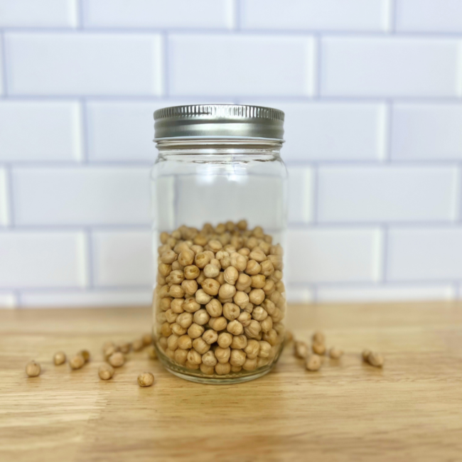 Dried garbanzo beans in a clear mason jar