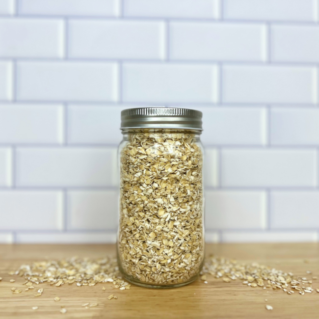 Uncooked quick oats in a clear glass mason jar