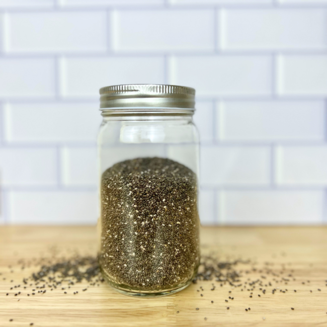 black chia seeds in a clear mason jar