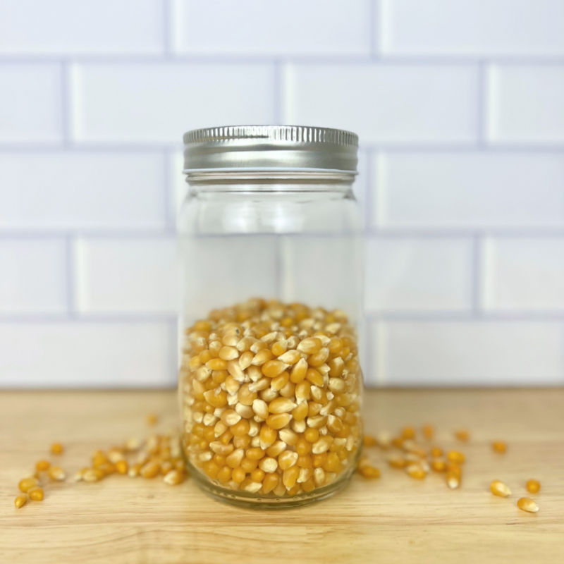 yellow popcorn kernels in a clear mason jar