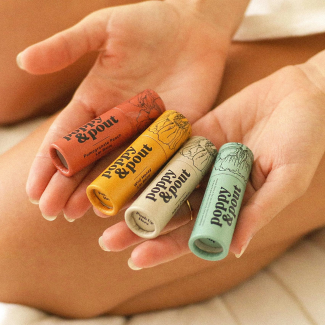 4 different flavors of lip balm held in someone's palms